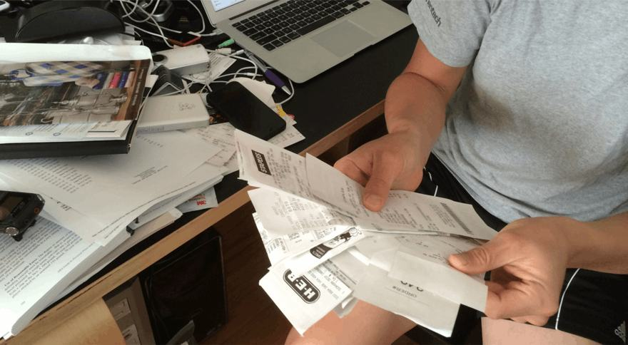 Contextual inquiry: a customer sorting a trip's worth of paper receipts at their desk